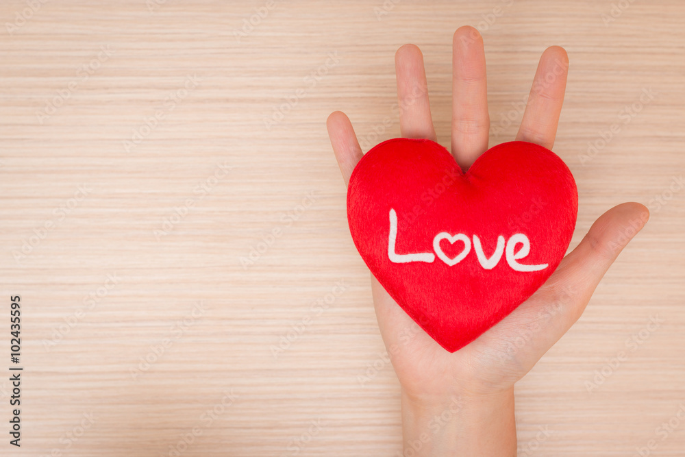 Hand giving red heart Hand giving red heart