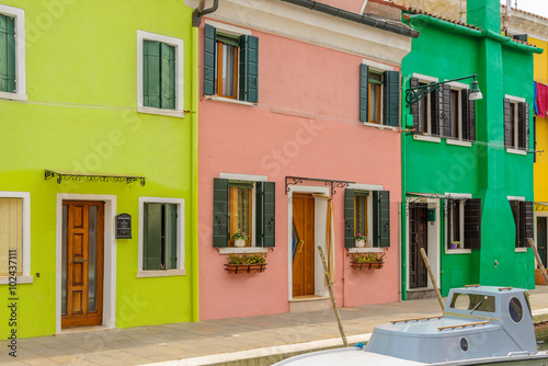 Colorful apartment building with nice waterfront view in Burano, Venice, Italy. © karamysh