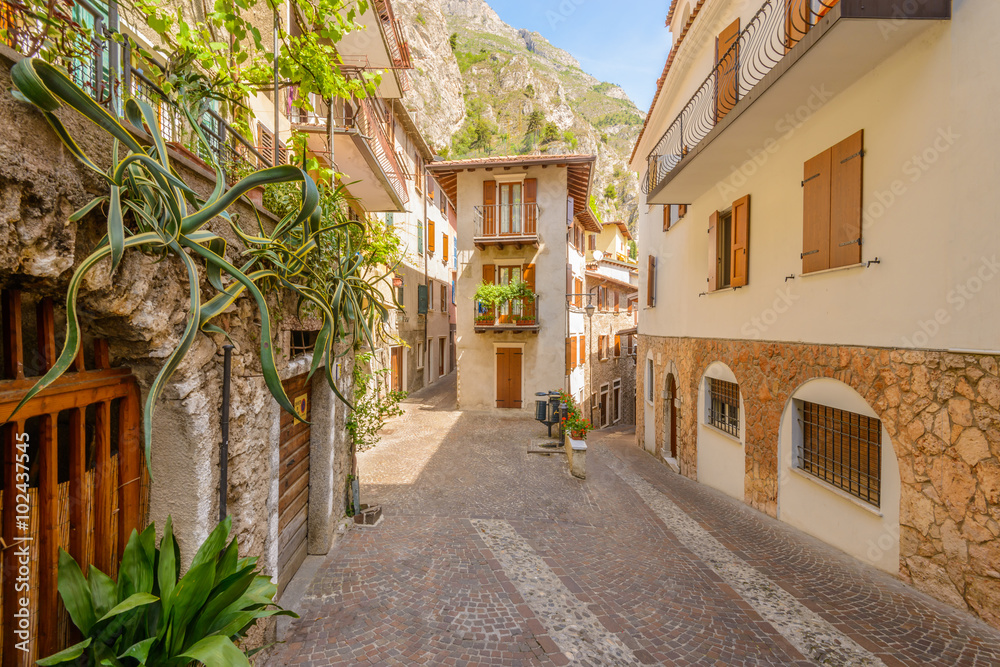 Narrow street of old apartment buildings in Malcesine, Italy.