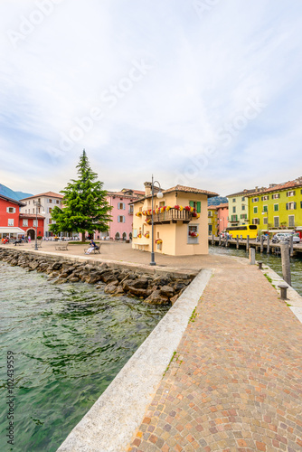 Harbor view and colorful apartment buildings in Torbole, Venice, Italy.