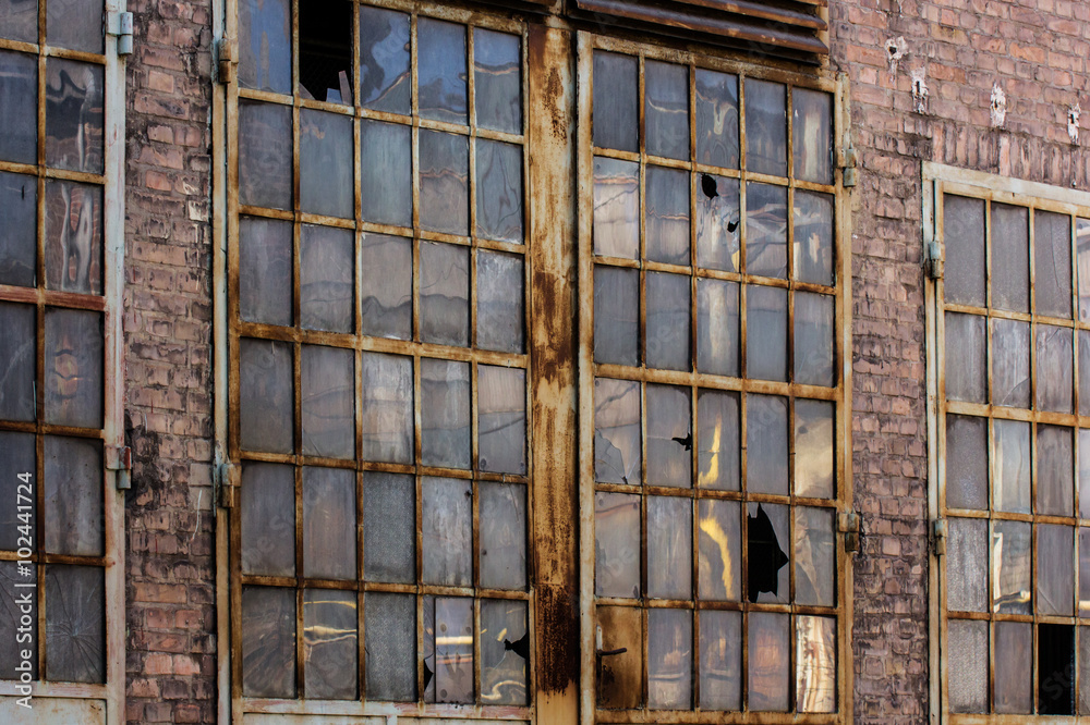 Broken windows in rusted industrial building