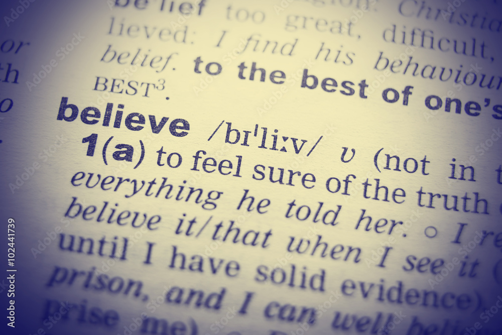 Closeup of word in English dictionary. Belief, definition and