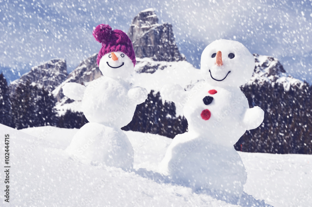 Funny snowmen against Swiss Alps