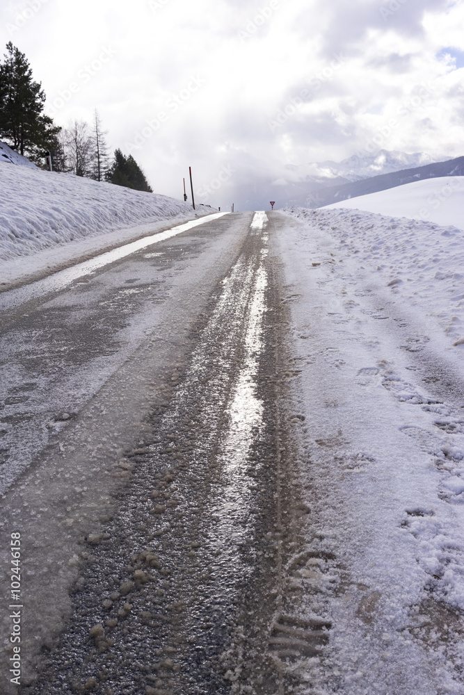 Low angle view of dirty snow with tyre tracks