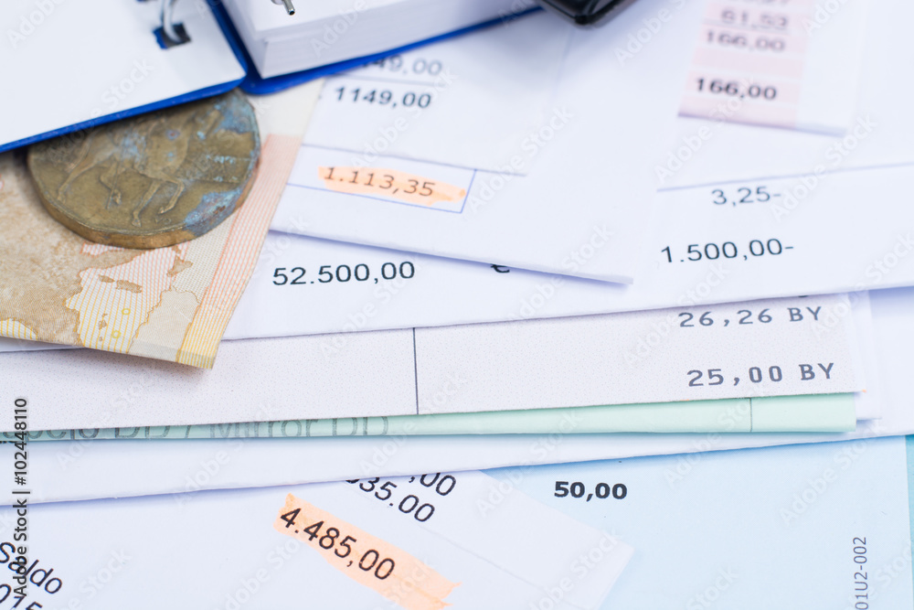 Mortgage and utility bills, coin and banknote, calculator, closeup Mortgage and utility bills, coin and banknote, calculator, closeup