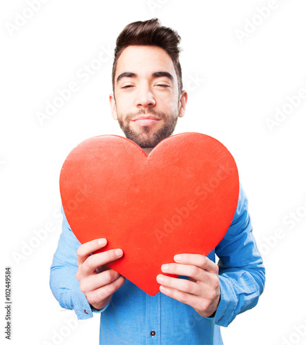 nerd man holding a heart object © asierromero
