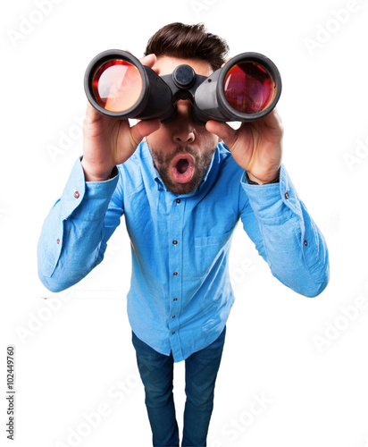 young man using binoculars