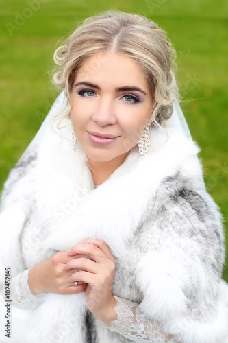 Beautiful smiling bride winter portrait. Attractive girl wearing