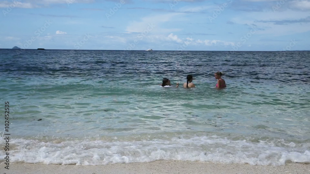 Happy family playing in the sea, splash water on a sunny day.Travel concept.Family,summer vacation. Happy family playing in the sea, splash water on a sunny day.Travel concept.Family,summer vacation.