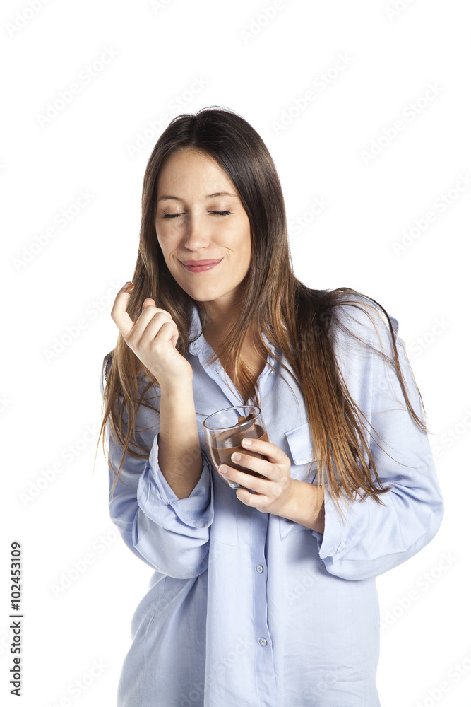 Young woman taking chocolate spread from a jar. Isolated on white background