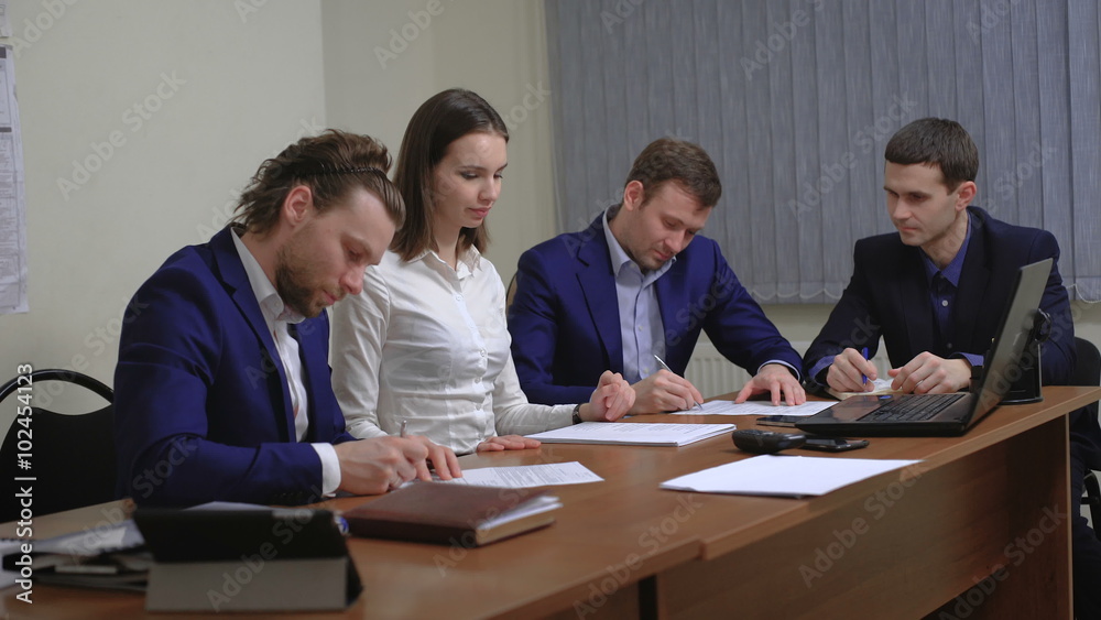 Two business people in elegant suits. Working in team together with documents sign up contract. Two business people in elegant suits. Working in team together with documents sign up contract.
