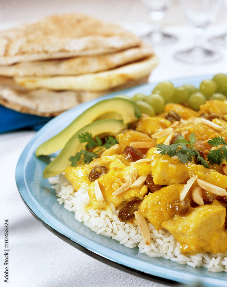 Curry Chicken with raisons and almonds on white rice. Curry Chicken with raisons and almonds on white rice.
