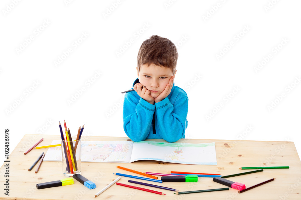 Sad little boy draw with crayons Sad little boy draw with crayons