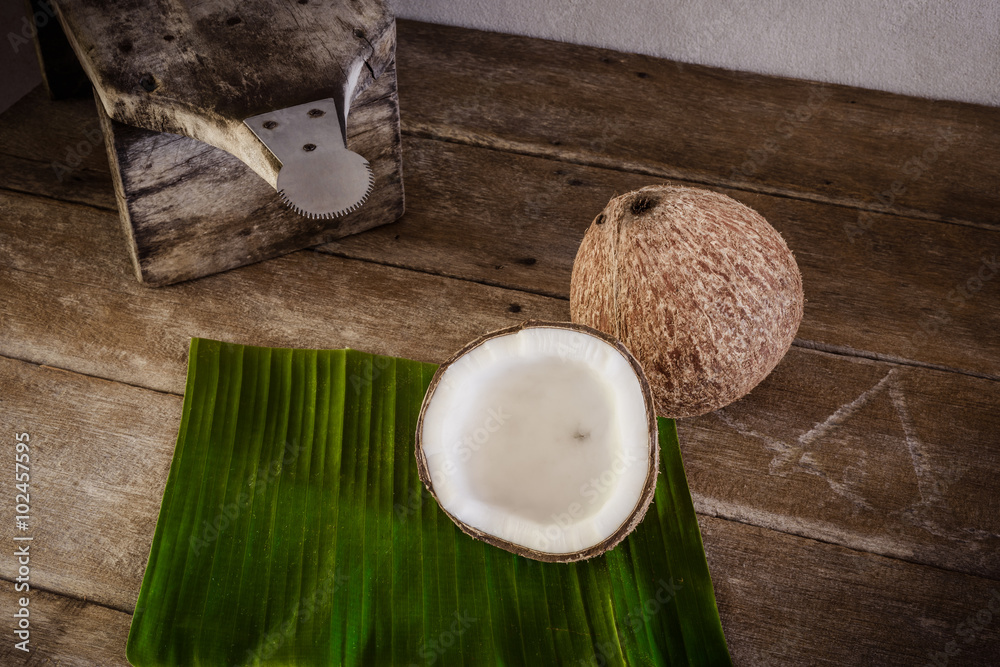 coconuts on banana leaf and coconut grater Stock Photo | Adobe Stock