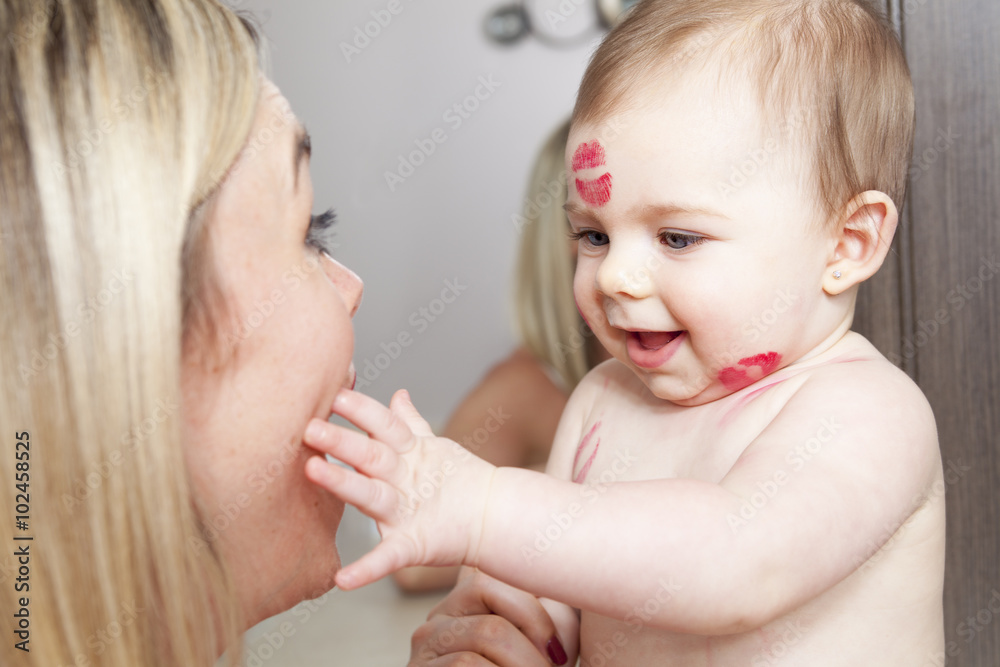Mother kissing her baby, close up portraits Mother kissing her baby, close up portraits