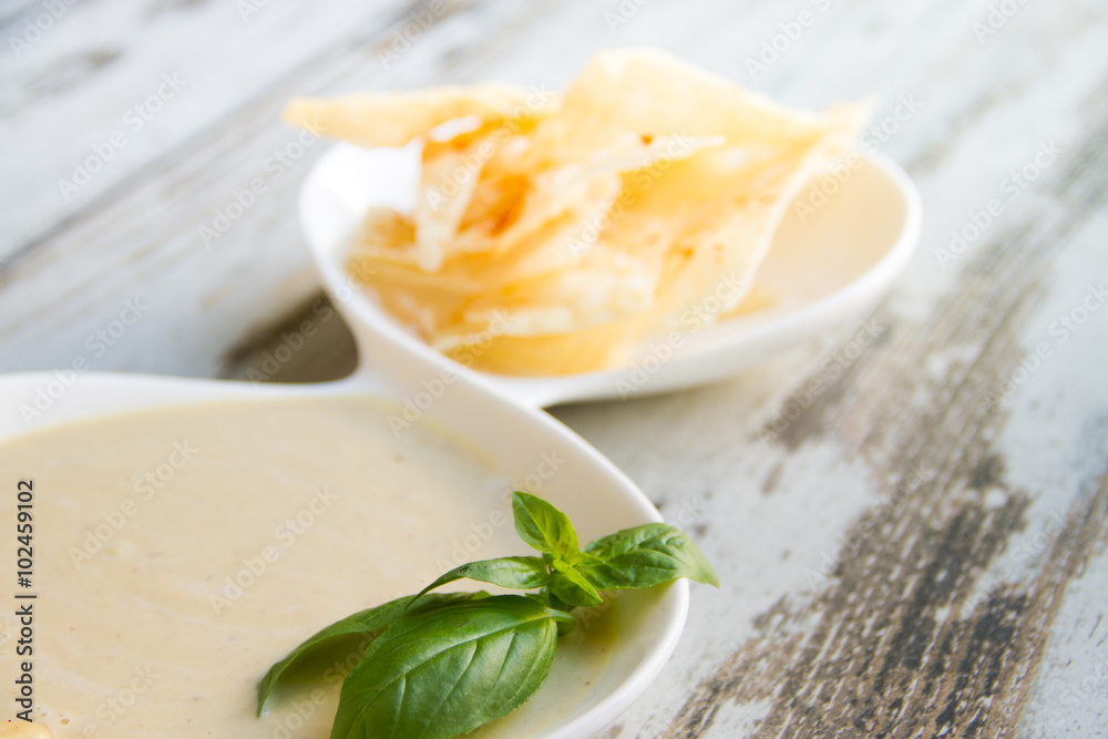Delicate hummus with chips on a white plate Delicate hummus with chips on a white plate