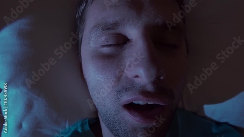 Snoring man in bed at home