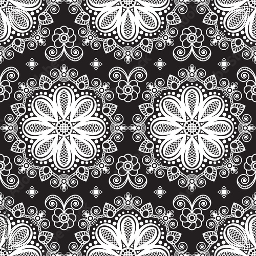 Seamless pattern mehndi background with flowers and lace buta decoration items on black background.