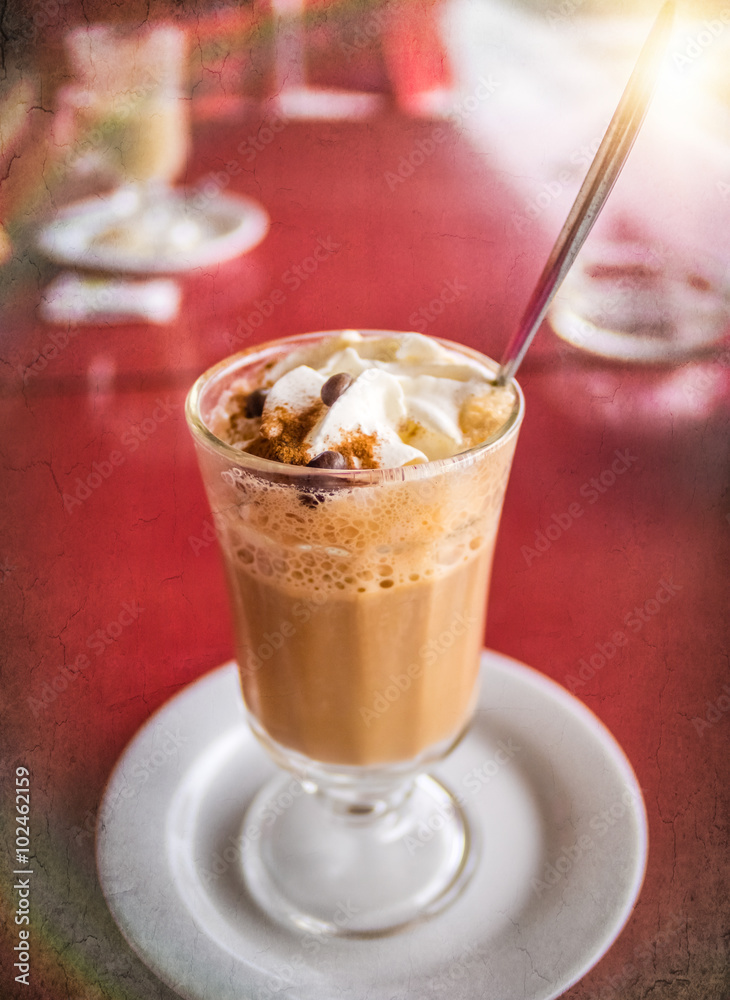 Coffee latte with whipped cream and cinanmon