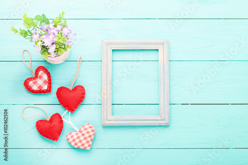 Valentine's accessories with heart shapes on blue wooden table. Top view. Mock up for text.