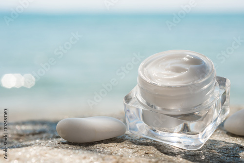 Natural facial cream and sea as background  photo