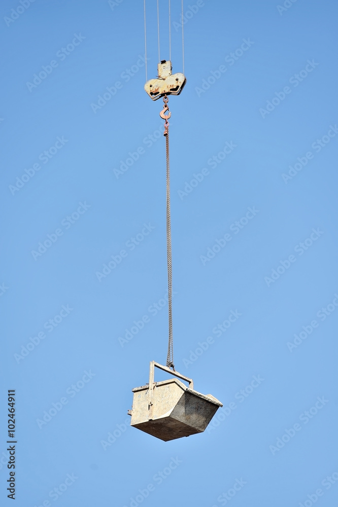 Construction crane loading a container Construction crane loading a container