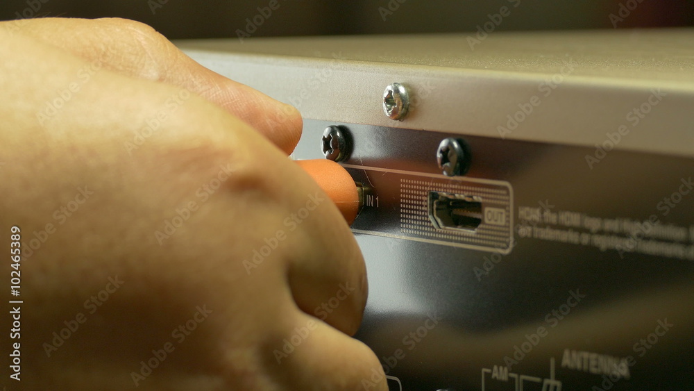 A close-up shot of a workman plugging-in an HDMI cable to the back of :Ultra HD 4K High quality footage size (3840x2160)