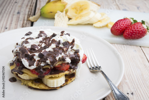pancakes with strawberries, banana, blueberries and chocolate...