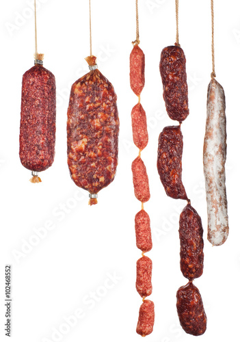assorted salami sausages isolated on white background