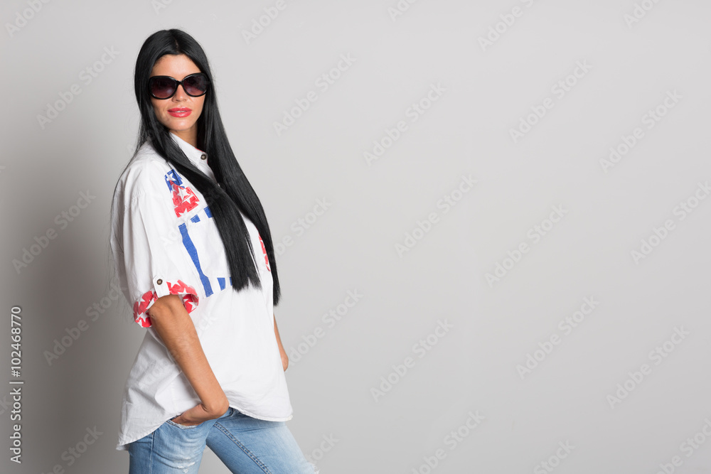 Young girl posing on a background of gray wall Young girl posing on a background of gray wall