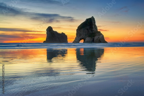 Sunset at  Wharariki Beach, South Island New Zealand photo
