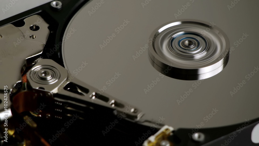 Hard Disk Drive Spinning with Arm Reading Blue Spindle Hard Disk Drive Spinning with Arm Reading Blue Spindle