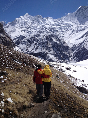 Local guide help trekker during trekking at Annapurna base camp