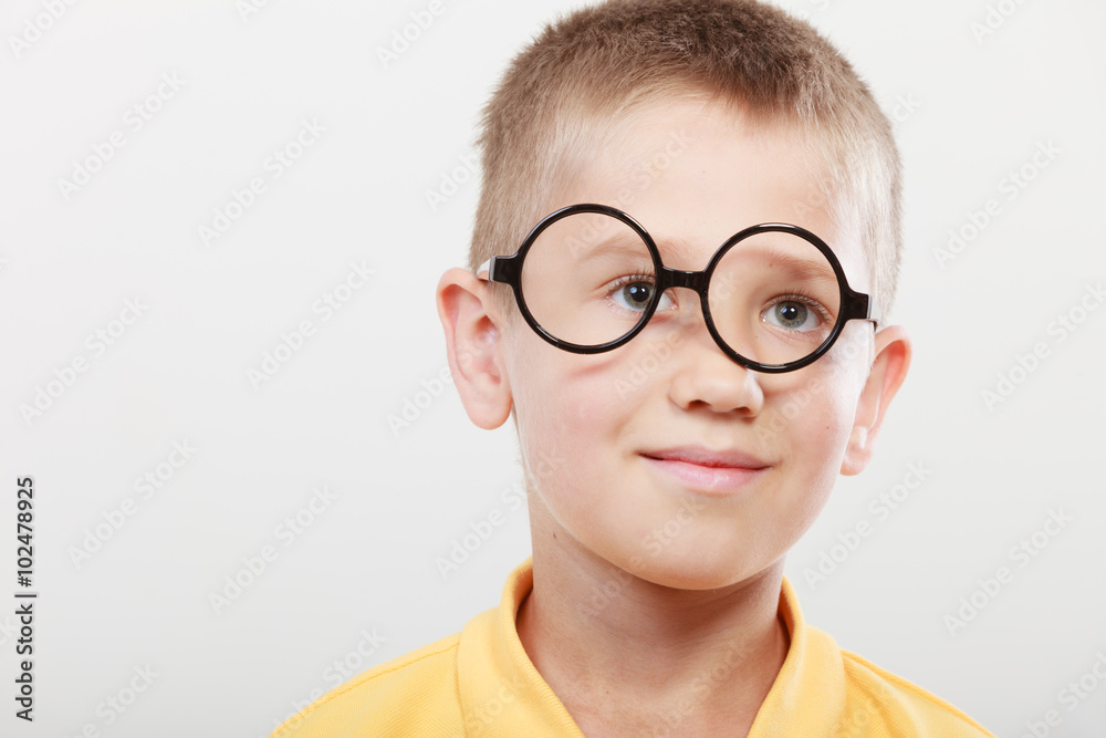 Portrait of serious kid little boy in glasses.