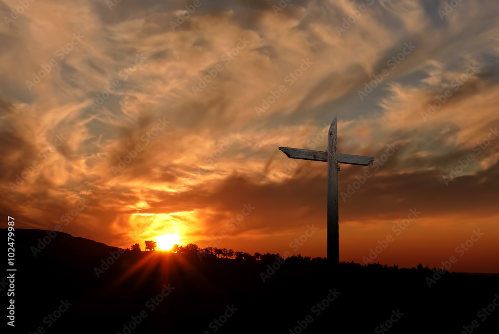 Christian cross over sunset background Christian cross over sunset background