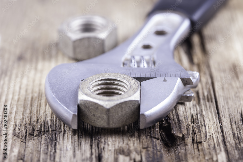 wrench background on grungy wood surface wrench background on grungy wood surface