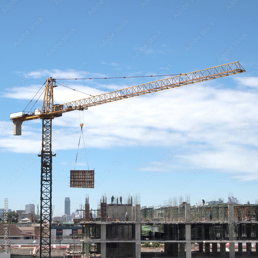 Industrial landscape with cranes on the blue sky
