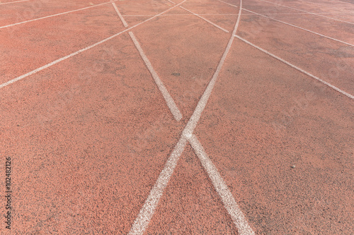 Sport background. White break lines on red tracks
