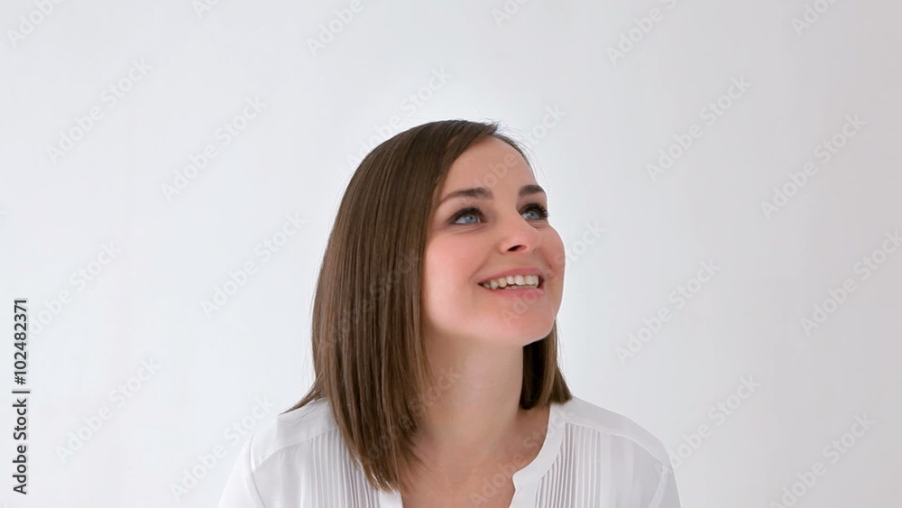 Woman watching something moving around her head. At the end she looks at camera. Copy space. Woman watching something moving around her head. At the end she looks at camera. Copy space.