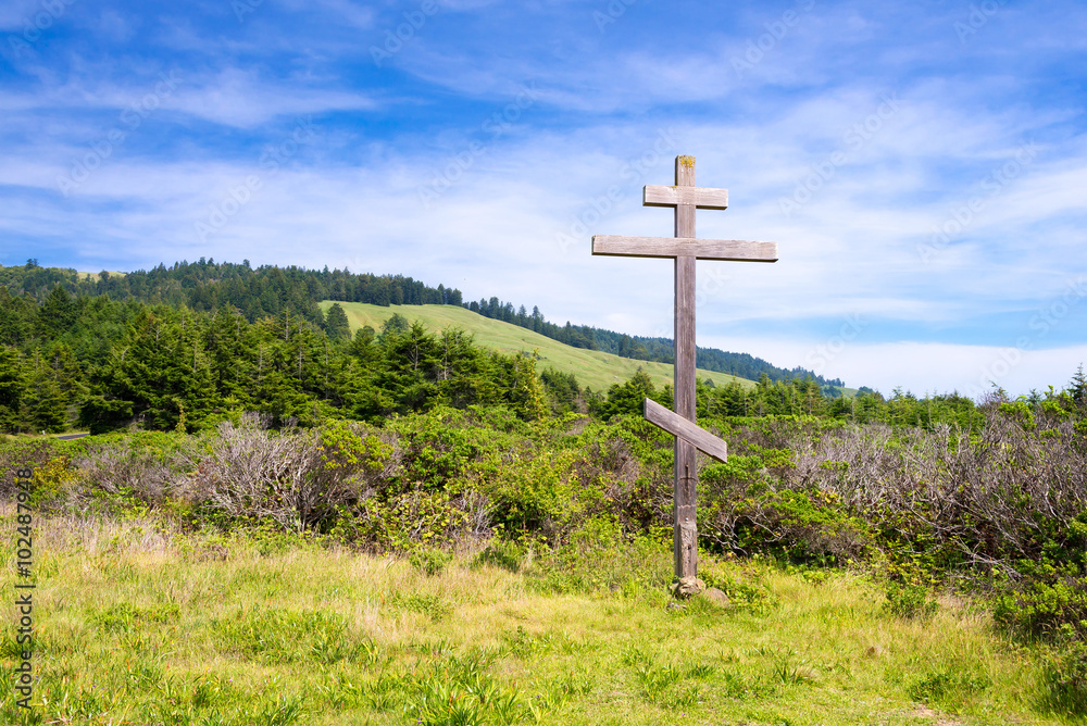 old wood cross with hills on background old wood cross with hills on background