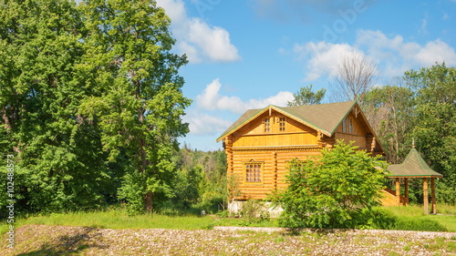 Wooden log house with a nice porch in the forest