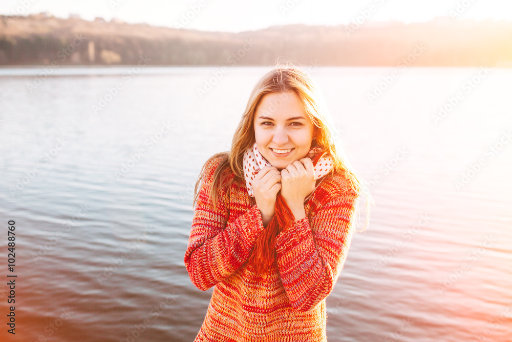 Happy hipster girl smiling at lake