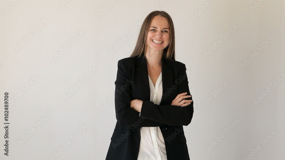 Young woman turns and starts laughing looking at camera with arms crossed