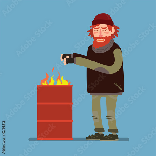 Sad homeless heated standing near barrel with fire