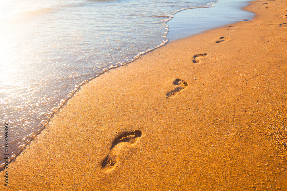 beach, wave and footprints at sunset time beach, wave and footprints at sunset time