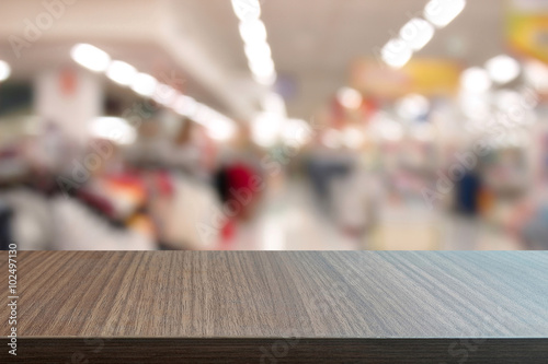 Top of wood table on  blurred  in department stores. you can be used for display your products