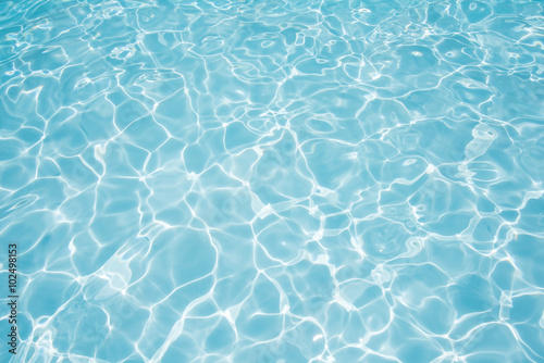 Clean and bright water in swimming pool with sun reflection