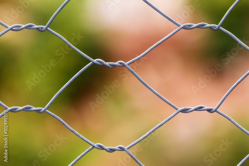 Close up of a fence with soft natural colors in the background