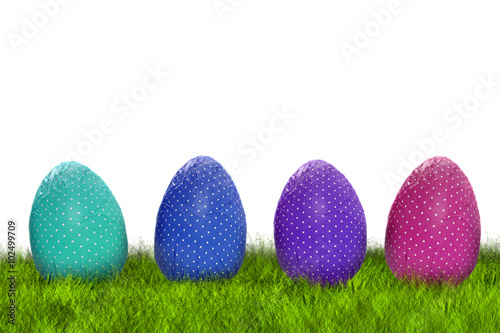 Wrapped Easter eggs on grass
