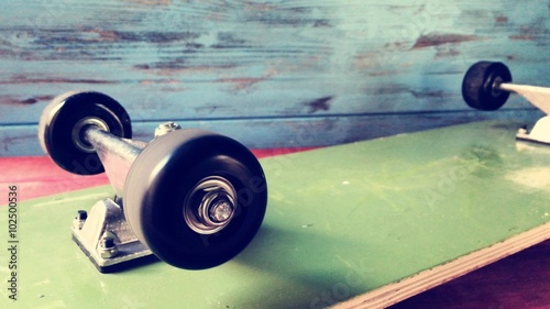 cinemagraph of a skateboard face down with its wheels spinning